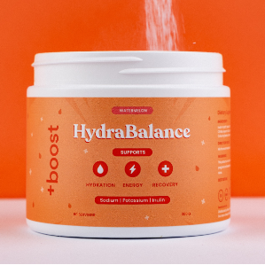 Person pouring powder into a HydraBalance container against an orange background