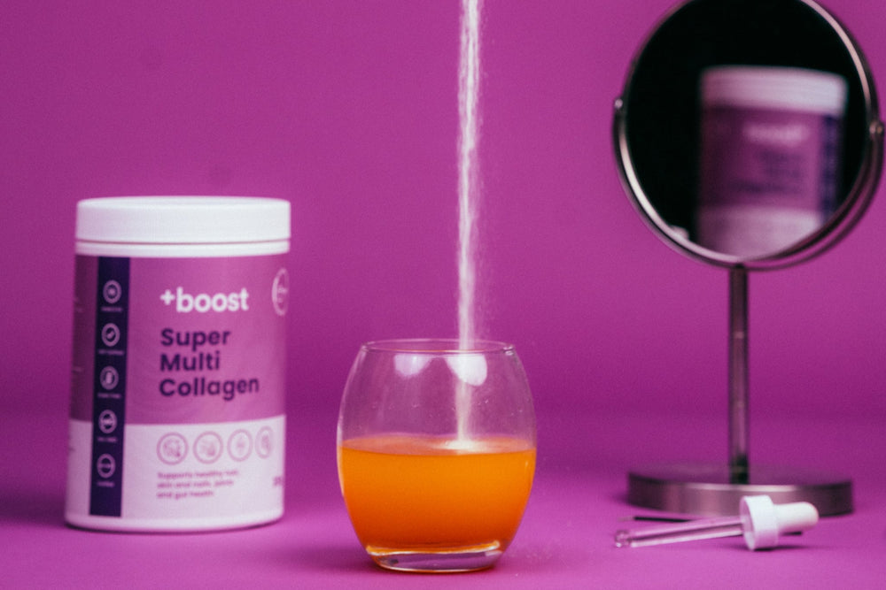 Person measuring Super Multi Collagen powder into a glass with a purple background