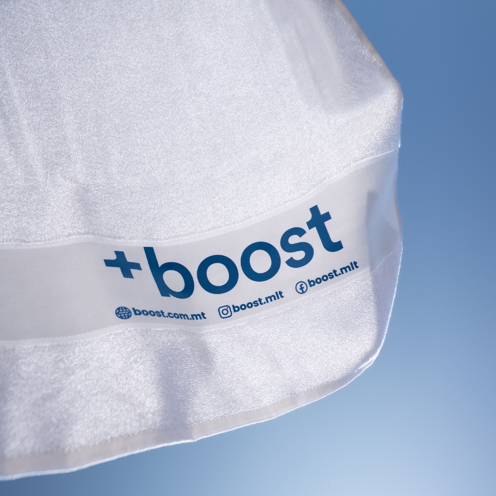 +boost gym towel with soft, absorbent fabric and +boost branding, shown folded on a white background.