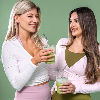 A +boost Matcha Latte in a glass mug, showcasing vibrant green matcha powder and creamy froth on top.